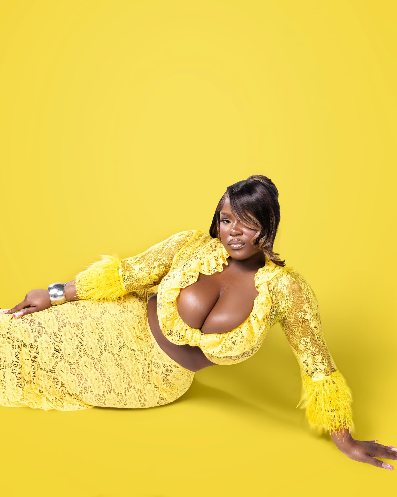 Markeena Novembre in a yellow lace outfit